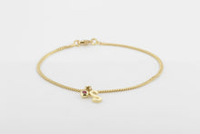 Afbeelding in Gallery-weergave laden, Armband van geslepen schakeltjes met letterhanger en bolle zetting met robijn, geelgoud